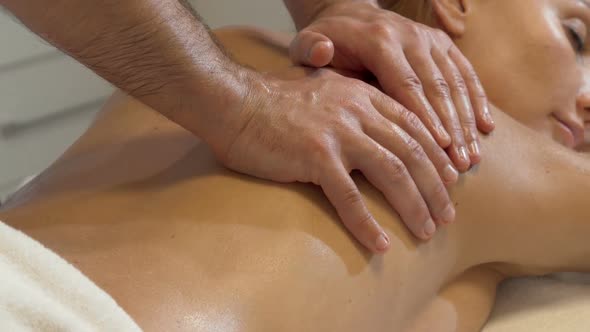 Sliding Shot of a Beautiful Woman Enjoying Body Massage at Spa Center