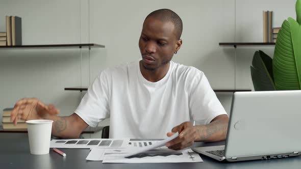 A Young Black Businessman Looks Puzzled He Has Problems He is Sitting in a Pose of Deep Thought alt