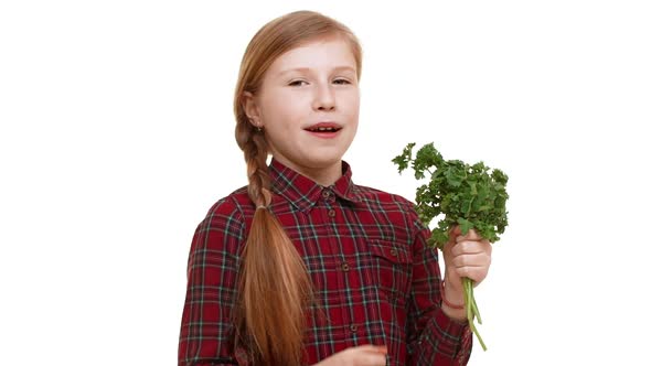 Elementaryschool Aged Caucasian Girl with Plait of Hair Holding Bunch of Greenery and Smelling It alt
