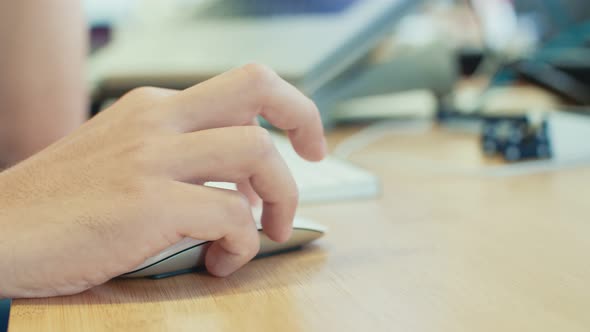 man hand working with wireless mouse on a desk alt