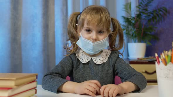 Preschool Child Girl Distance Online Learning at Home Cute Kid Pupil Studying Looking at Camera alt
