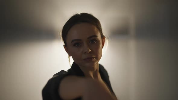 Smiling Adult Ballerina Dancing in Spotlight Looking at Camera alt