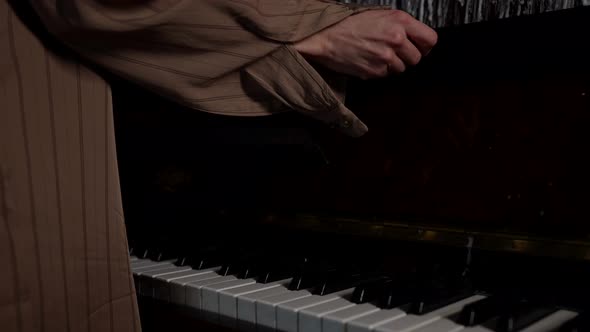 Woman is Opening Cap of Piano and Stroking Keys Closeup of Hands in Room alt