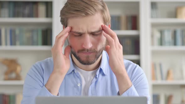 Portrait of Man Having Headache While Using Laptop alt