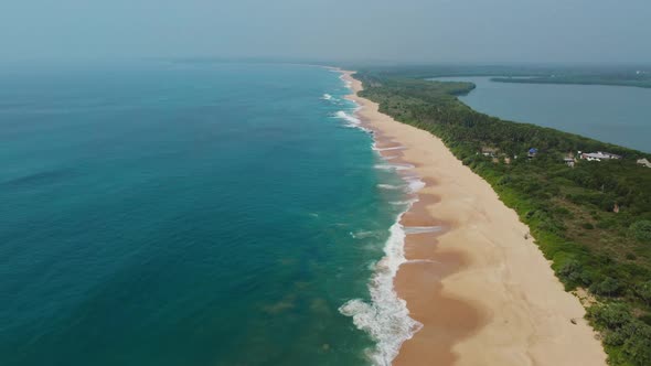 Sea coast, view from the height. Sandy beach with blue sea. alt