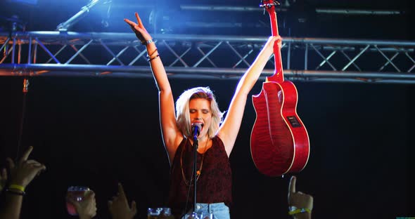 Singer performing on stage alt