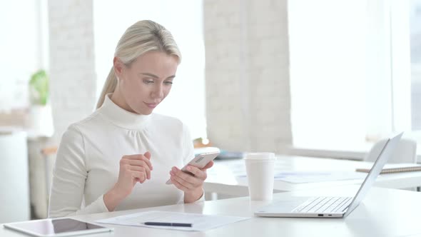 Successful Young Businesswoman Using Smartphone alt
