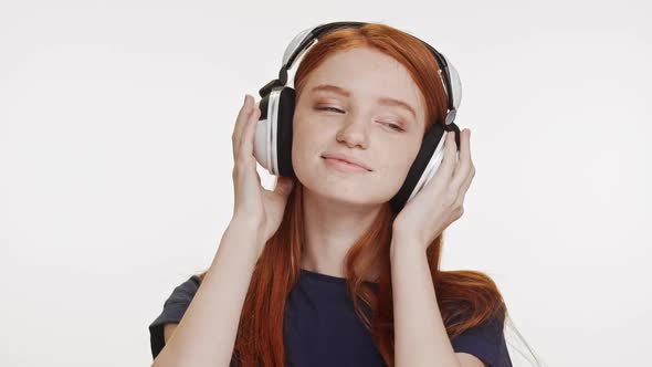 Young Beautiful Caucasian Foxy Teenage Girl Listening Music Through Headphones Dancing Smiling on alt