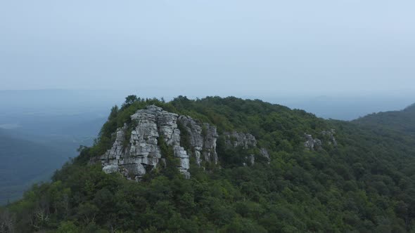 An aerial shot (dolly in) of Big Schloss and Great North Mountain in the evening in the summer, loca alt