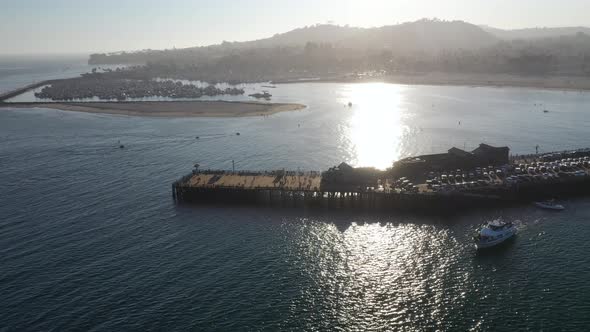 Panoramic View of Stearns Wharf with the Silhouette of a Mountain in the Background in Santa Barbara alt