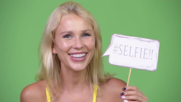 Young Happy Beautiful Blonde Woman with Selfie Paper Sign