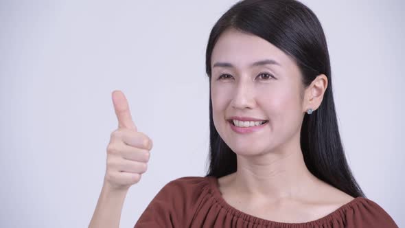 Face of Happy Beautiful Asian Woman Giving Thumbs Up alt