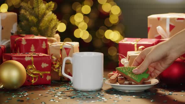 Hot Drink and Cookies on Table with Christmas Gifts and Decorations