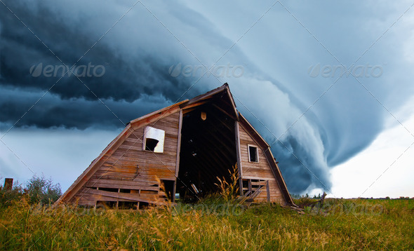 tornado forming behind old barn - Stock Photo - Images