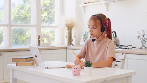 Teenage Girl Studying Online From Home with Distance Teacher