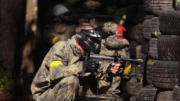 Paintball Sport Player Wearing Protective Mask Shooting alt