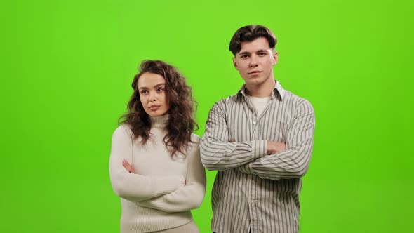 A Man and a Woman are Standing and Looking at the Camera alt