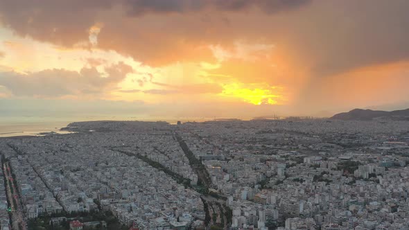 Aerial drone panoramic view of the Greek capital Athens at sunset with a sky overcast