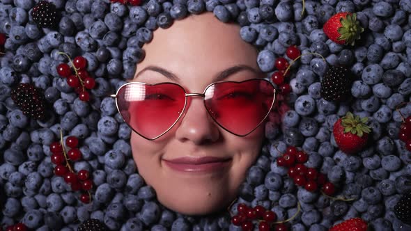 Happy Woman Face in Eyewear Fresh Ripe Berries  Blueberries Strawberries Currant alt