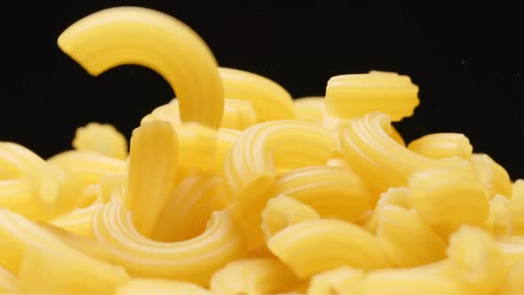 Macro shot of falling of macaroni on a heap