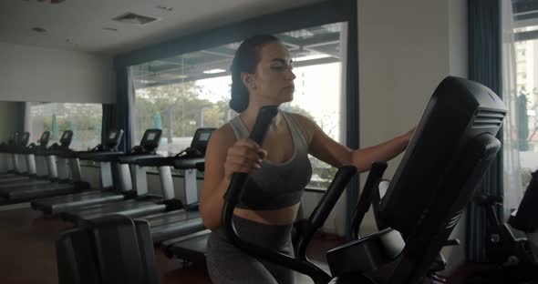 Young Indian Woman Working Out on a Treadmill in a Fitness Room alt
