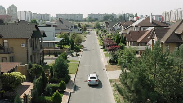 Establishing Shot of Cottage Township with Solar Photovoltaic Panels Arrays on the Roofs alt