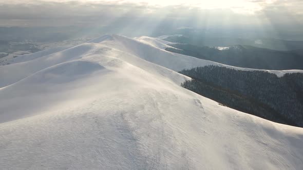 Amazing Aerial Flight Over Misty Mountain Range Meadows and Snow Covered Peaks in Winter Time