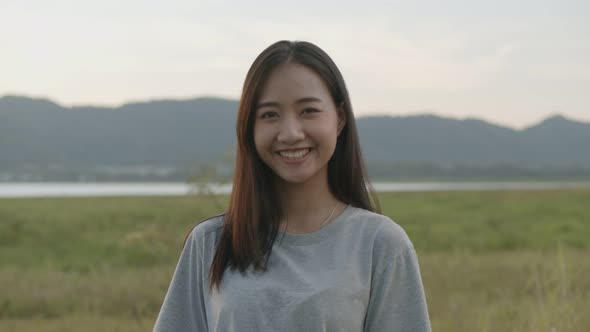 Portrait of beautiful young Asian woman smiling look at camera.