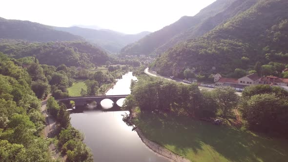 Drone View of the Embankment of the Crnojevica River Surrounded By Green Mountains alt