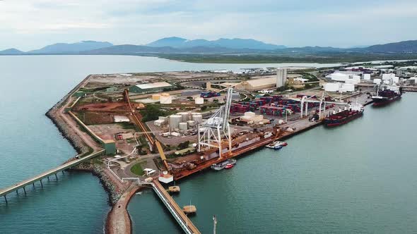 Drone footage slowly circling marine port facilities in Townsville, Australia. alt