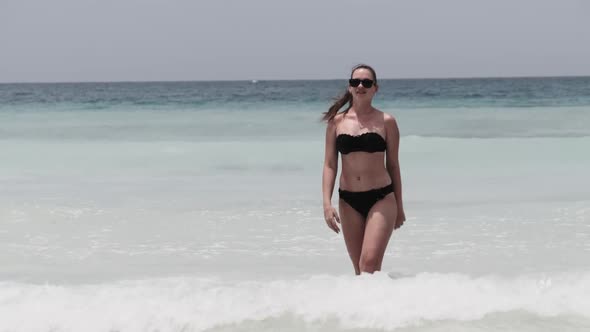 Young Woman in a Bikini Posing on Exotic Beach at the Turquoise Ocean Zanzibar alt