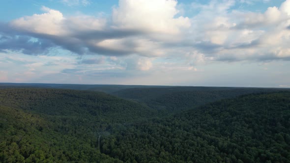 An aerial view of green hills with cloudy sky in the Allegheny National Forest alt
