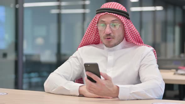 Middle Aged Arab Man doing Video Call on Smartphone in Office alt