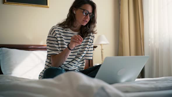 A Young Woman Freelancer Taking a Video Conference Meeting on Her Laptop alt