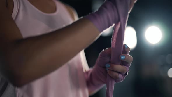 Close Up of a Athletic Woman is Wrapping Her Hands with Bandages in the Gym alt