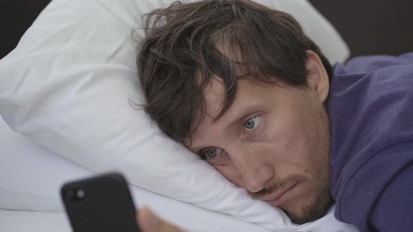 Closeup Shot of a Young Man in Mandatory Quarantine. He Stays in One Room for Two Weeks. He Lay on a alt