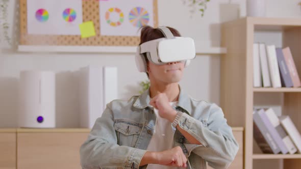 Young male uses virtual reality glasses looking learning alt