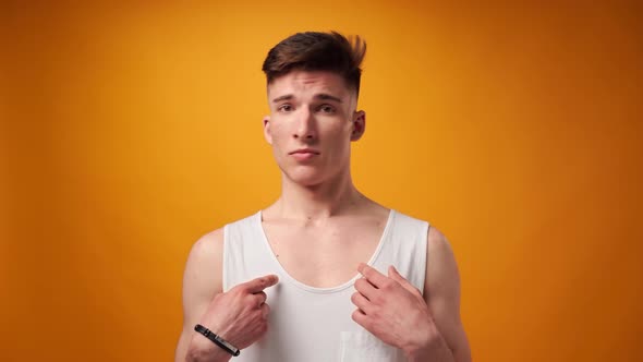 Young Man Points on Himself and Says "No" Not Me Doesn't Know Against Yellow Background alt