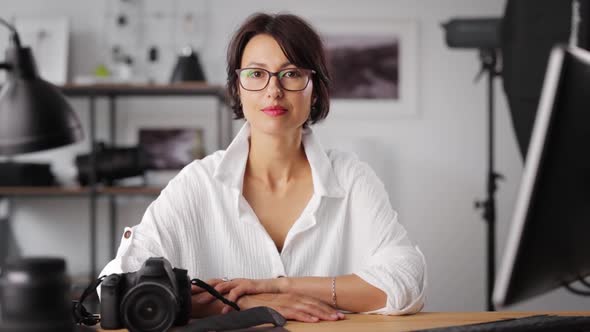 Female Photographer Sitting at Office