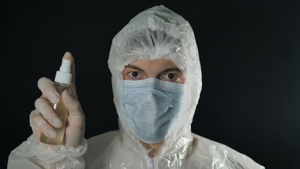 Disinfection and Hygiene Treatment From Coronavirus Doctor in White Suit Presses Antiseptic and alt