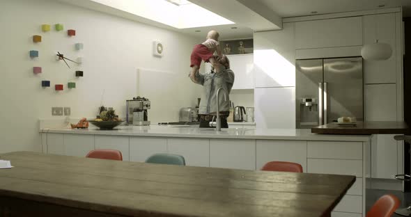 Father playing with his daughter in kitchen