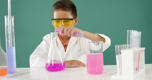 Schoolboy doing a chemical experiment in laboratory 4k alt