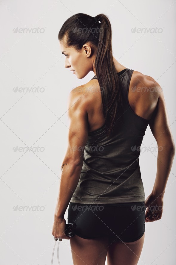 Fitness female showing muscular back – Jacob Lund Photography