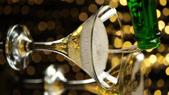 Pouring Champagne over Holiday Bokeh Blinking Background. Vertical video