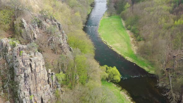 Aerial view of River flowing through the valley of forests alt