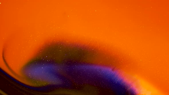 Orange Background with Shiny Purple Particles in Slow Motion
