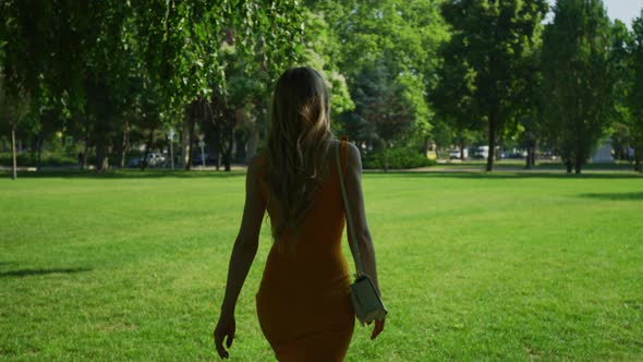 Woman walking in a park alt