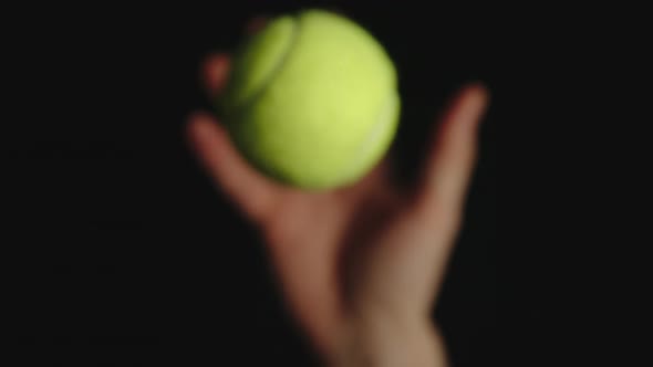 Tennis ball is tossed and caught