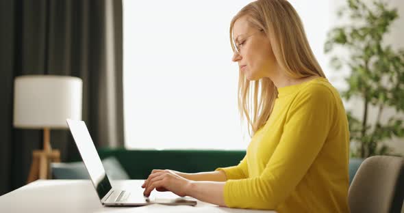Woman Working on Laptop at Home