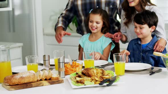 Family having healthy meal together at home alt